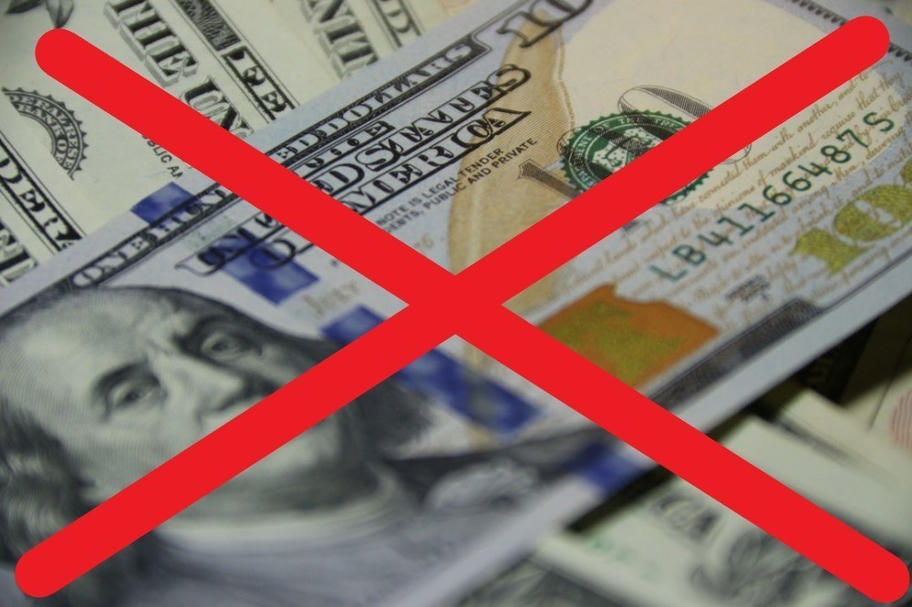 hundred dollar bills with big red across them